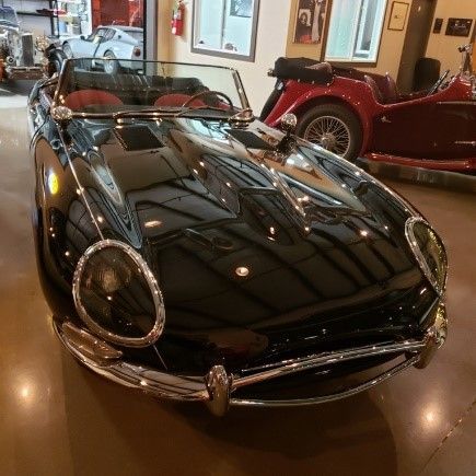Black convertible car in showroom.