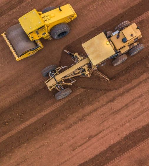 An Aerial View of Two Construction Vehicles — Watto's Earthmoving & Machinery Hire in Atherton, QLD
