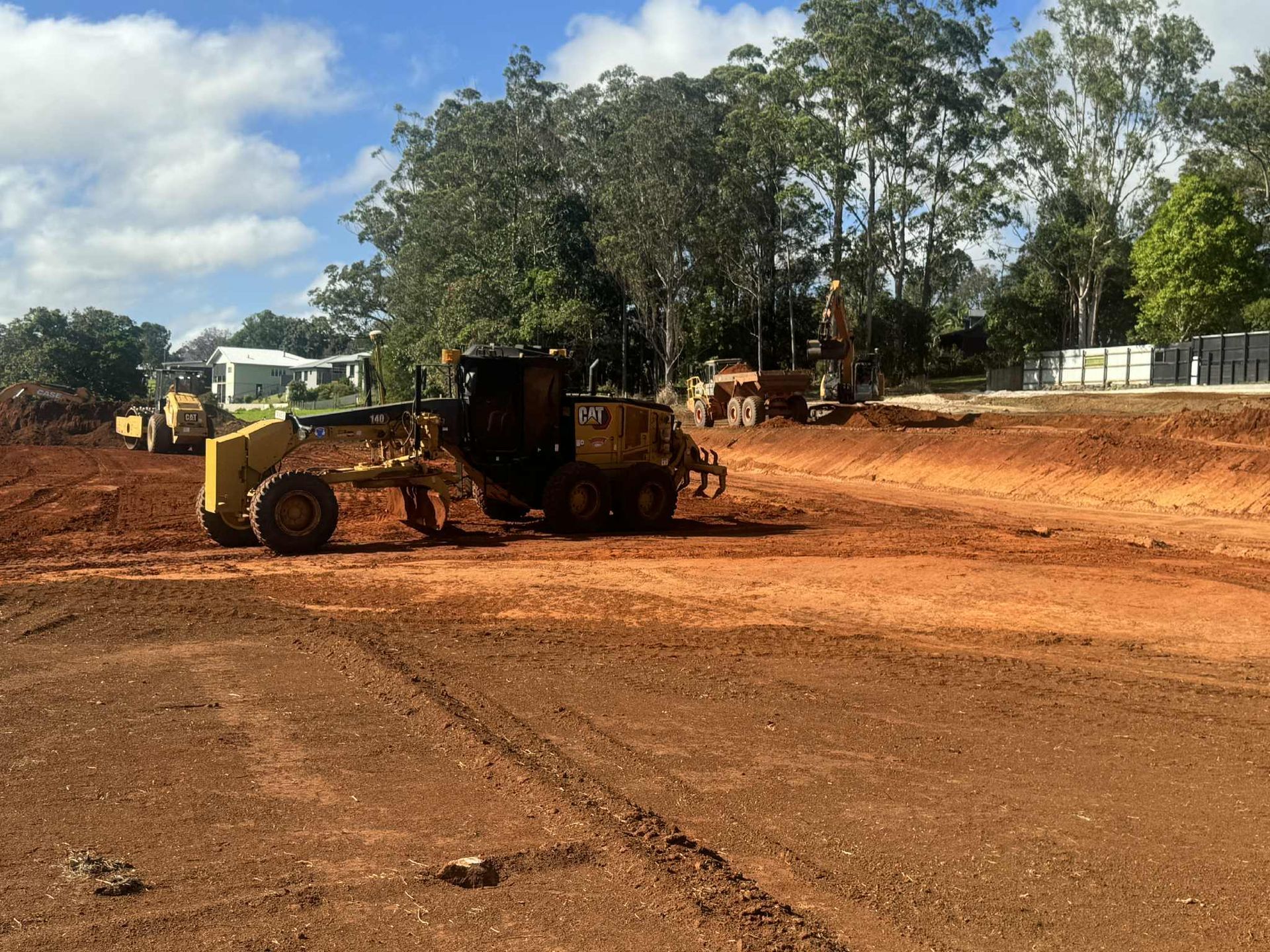 A Group of Construction Workers Are Working on A Building — Watto's Earthmoving & Machinery Hire in Atherton, QLD