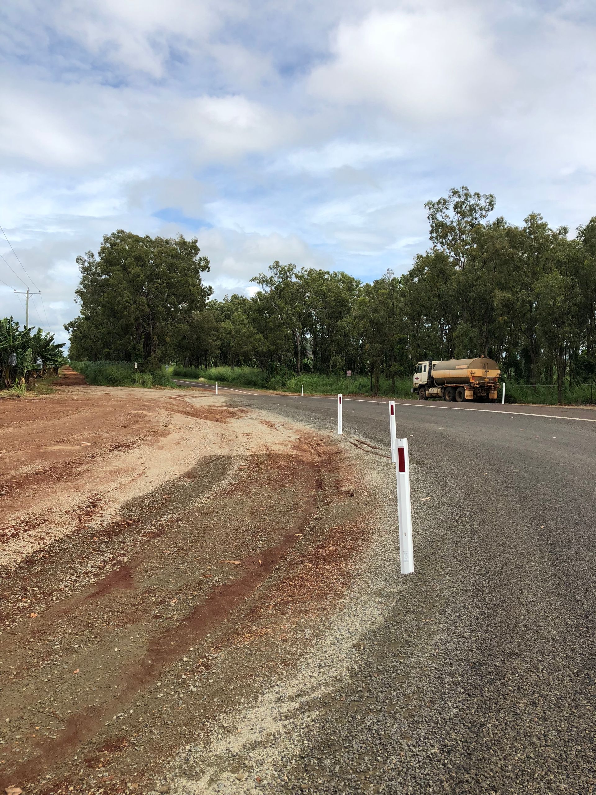 A Large Pile of Dirt Is Being Scooped up By an Excavator — Watto's Earthmoving & Machinery Hire in Atherton, QLD