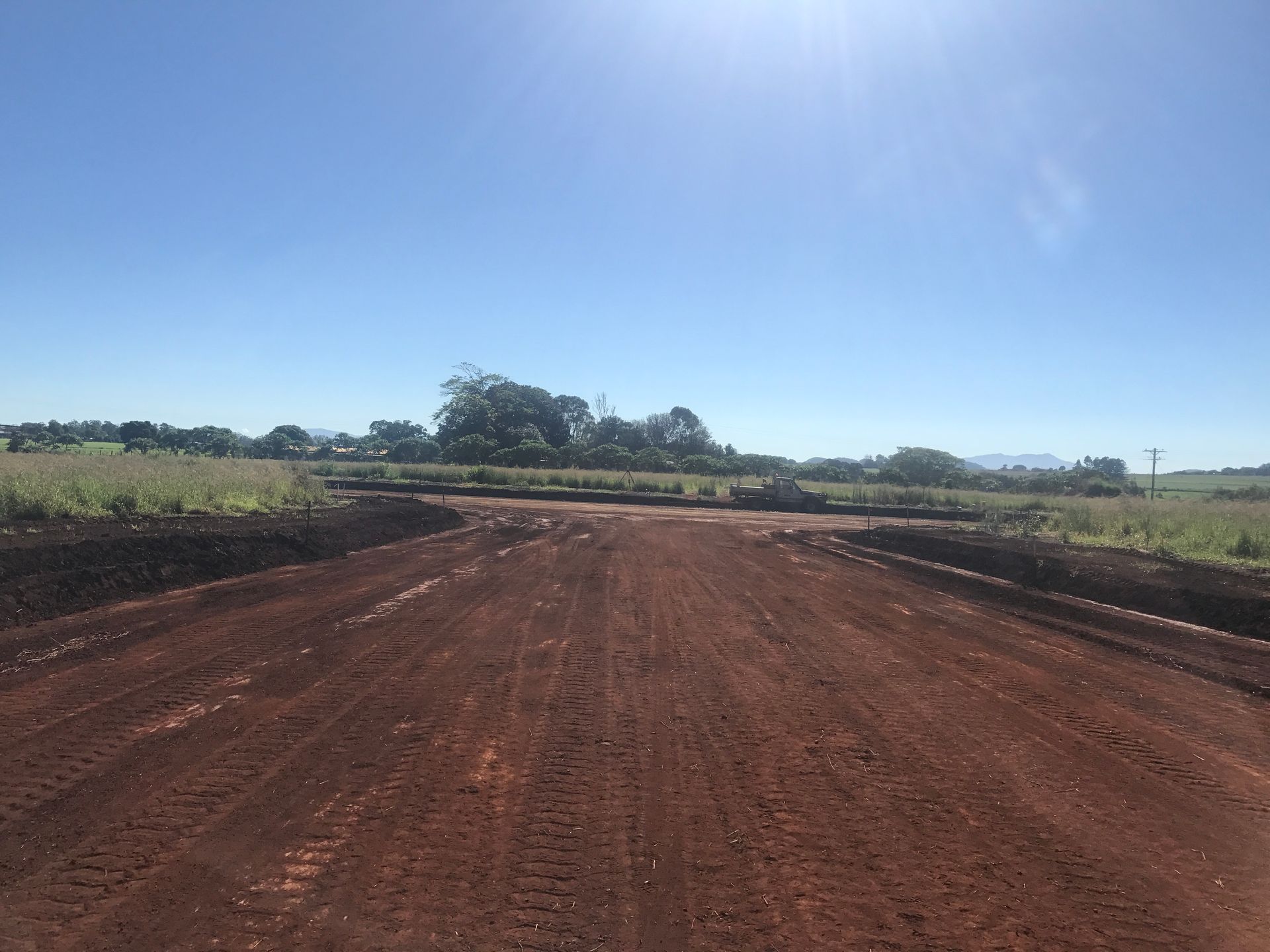 A Blue Scissor Lift Is Sitting on Top of A Building Under Construction — Watto's Earthmoving & Machinery Hire in Mareeba, QLD