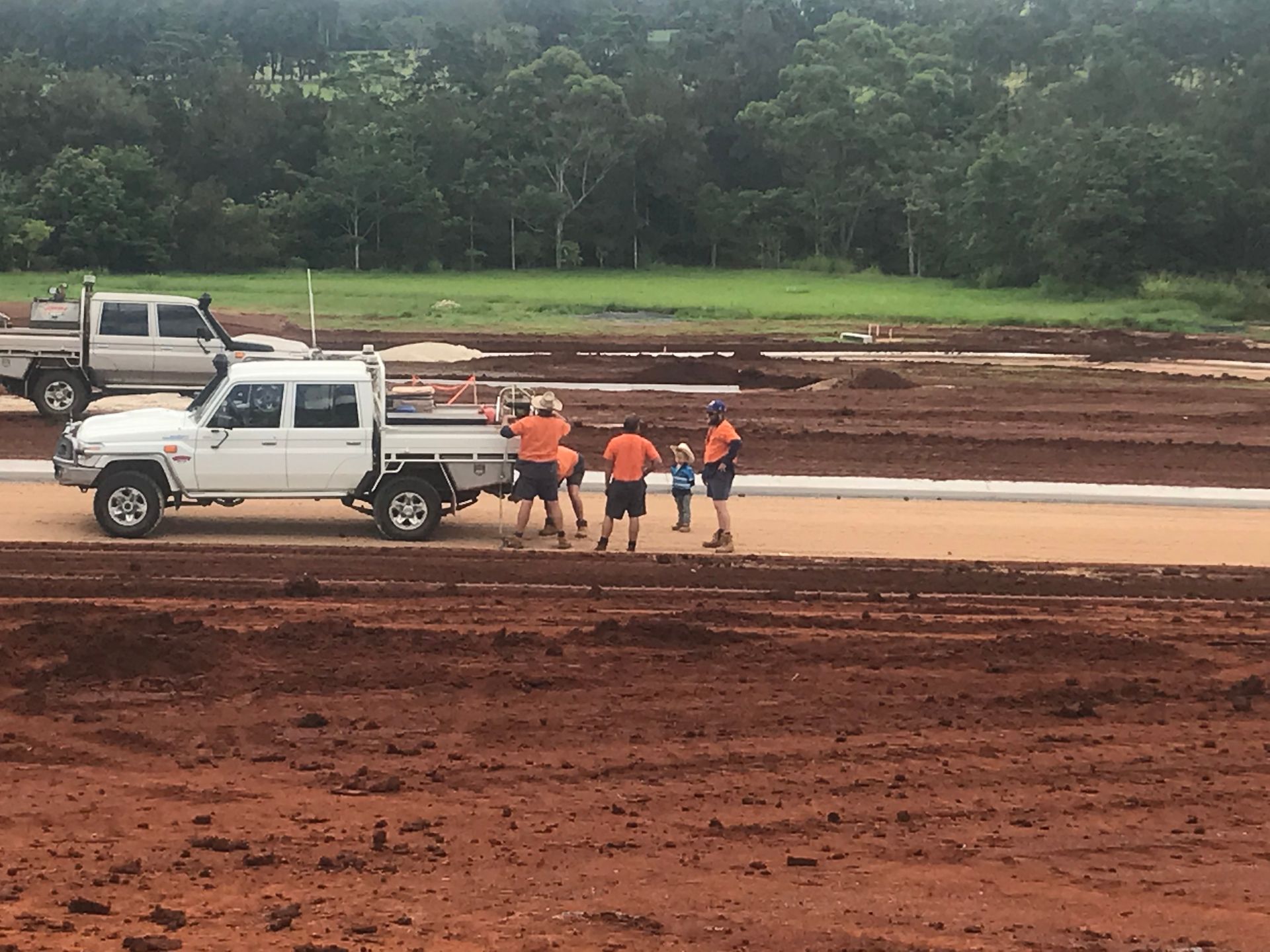 A Bulldozer Is Digging a Hole in The Dirt — Watto's Earthmoving & Machinery Hire in Atherton, QLD