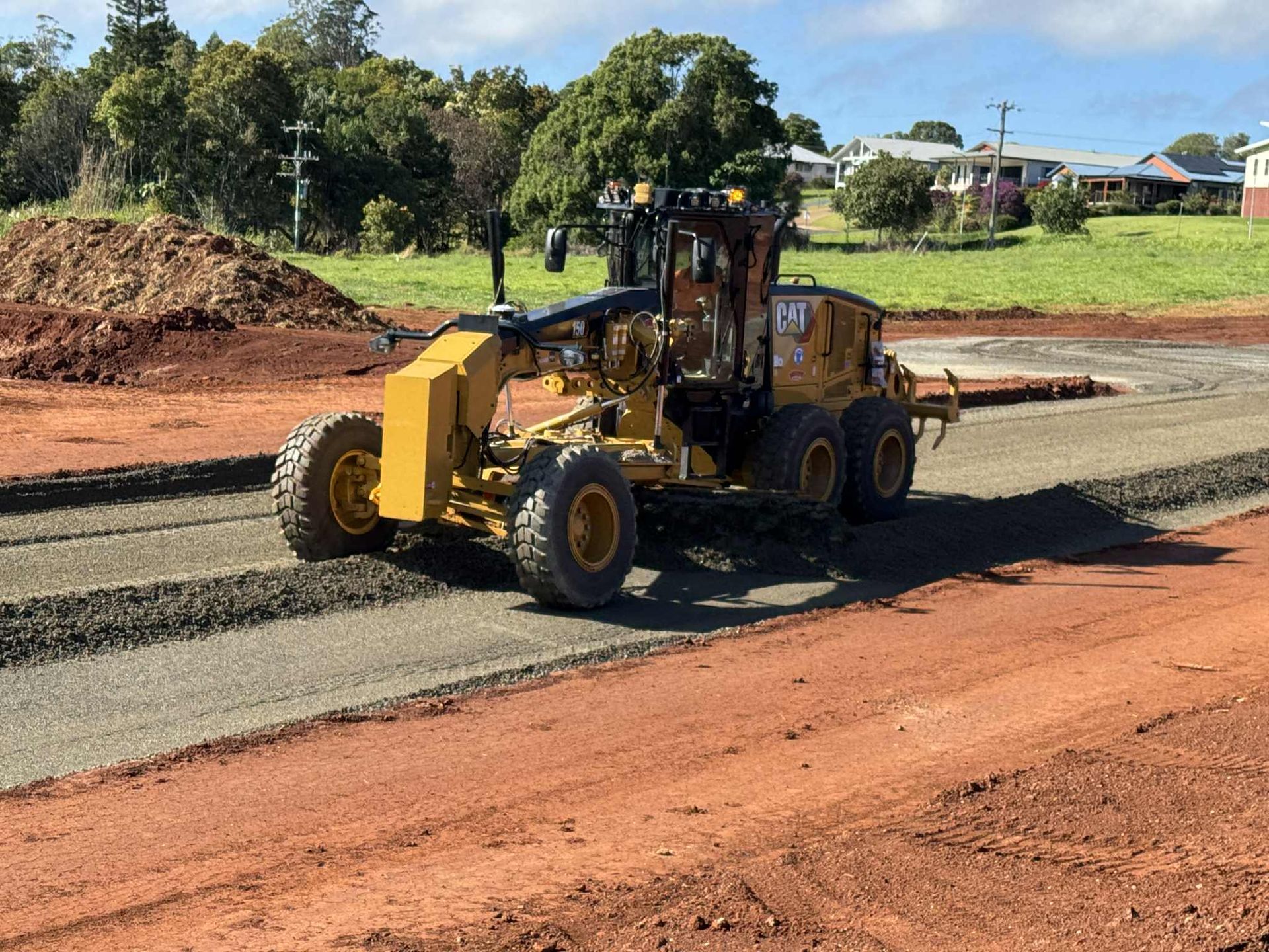 An Orange Road Roller Is Next to A Tow Truck — Watto's Earthmoving & Machinery Hire in Atherton, QLD