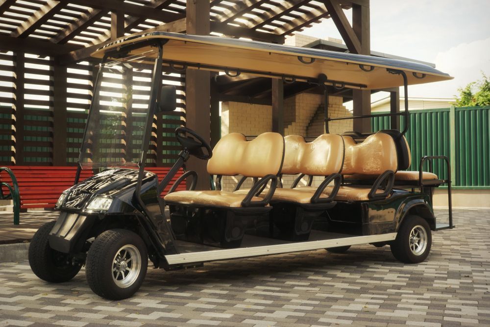 A Golf Cart With Six Seats is Parked in Front of a Building — Golf Carts Top End in Howard Springs, NT