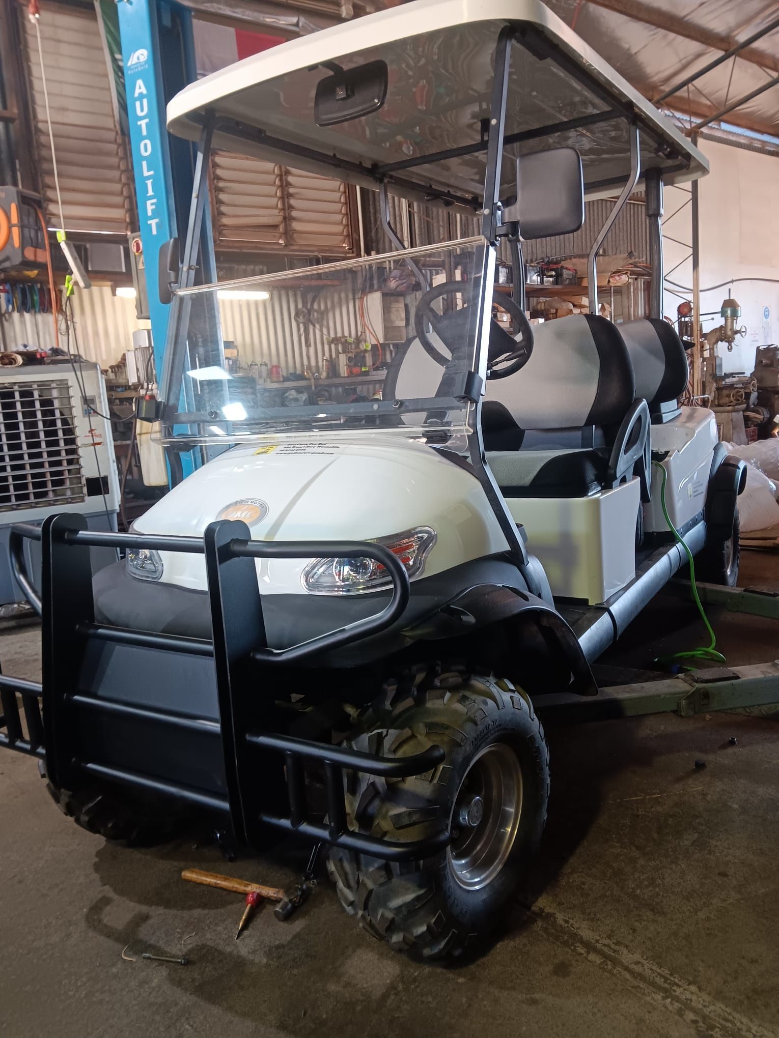 A Row of Golf Carts Are Parked in a Garage — Golf Carts Top End in Zuccoli, NT
