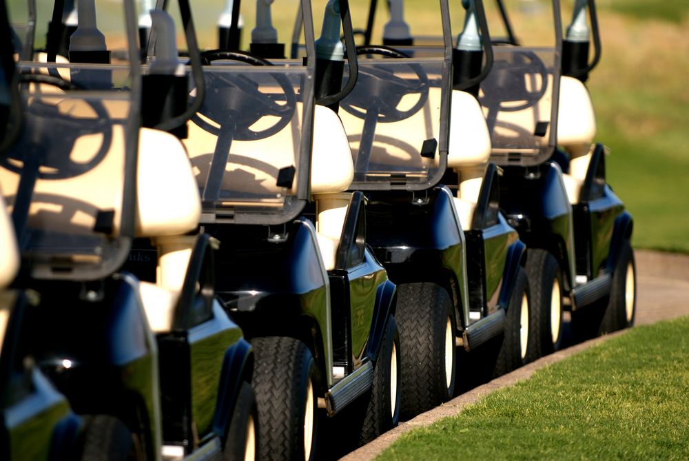 A Row of Golf Carts Are Parked on a Golf Course — Golf Carts Top End in Casuarina, NT