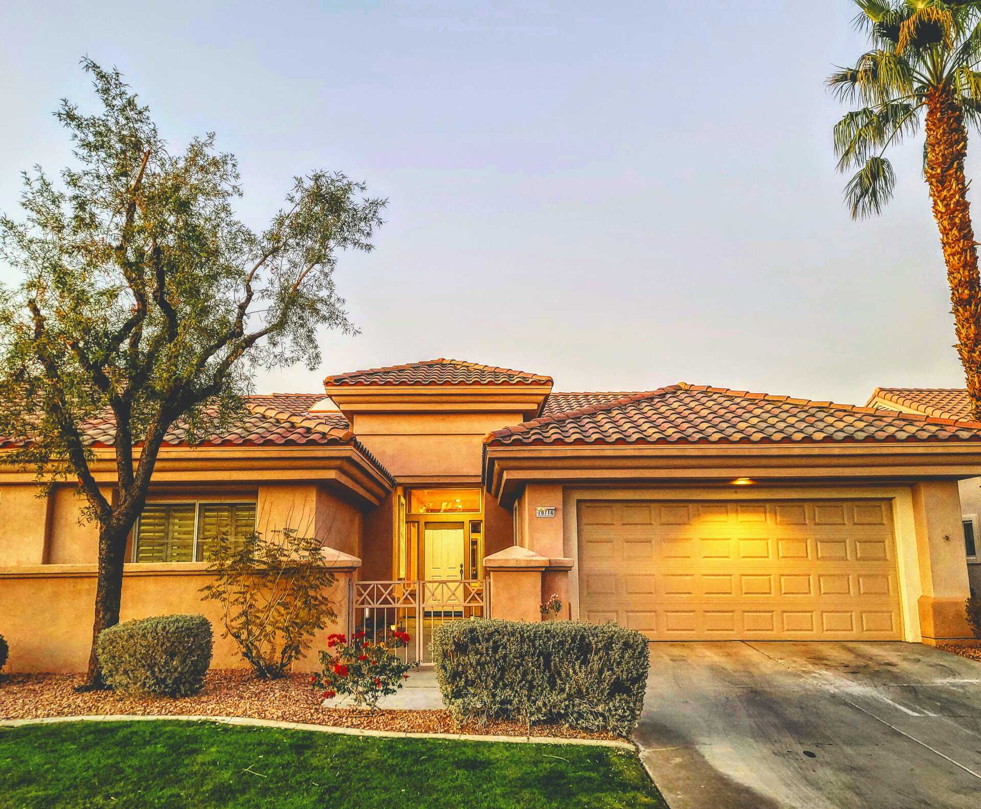 Large home with tile roof and garage