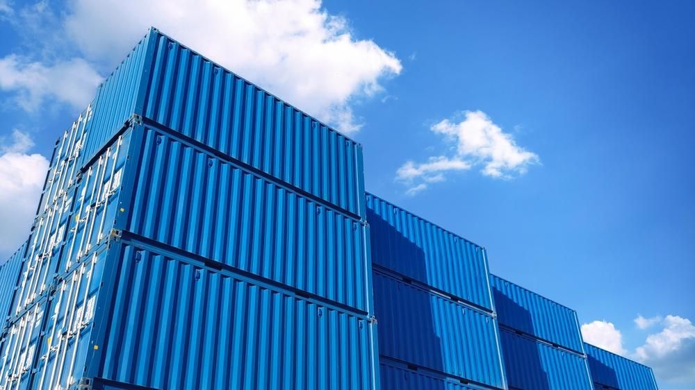 A Stack of Blue Shipping Containers Against a Blue Sky — Spinifex Container Solutions In Ciccone, NT