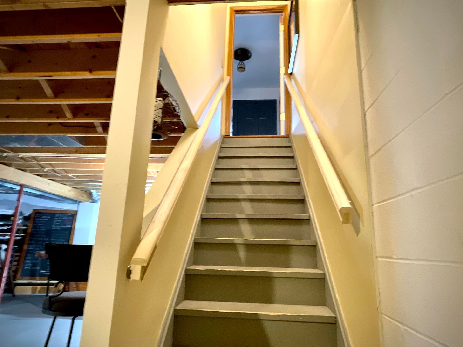 A set of stairs leading up to a doorway in a house