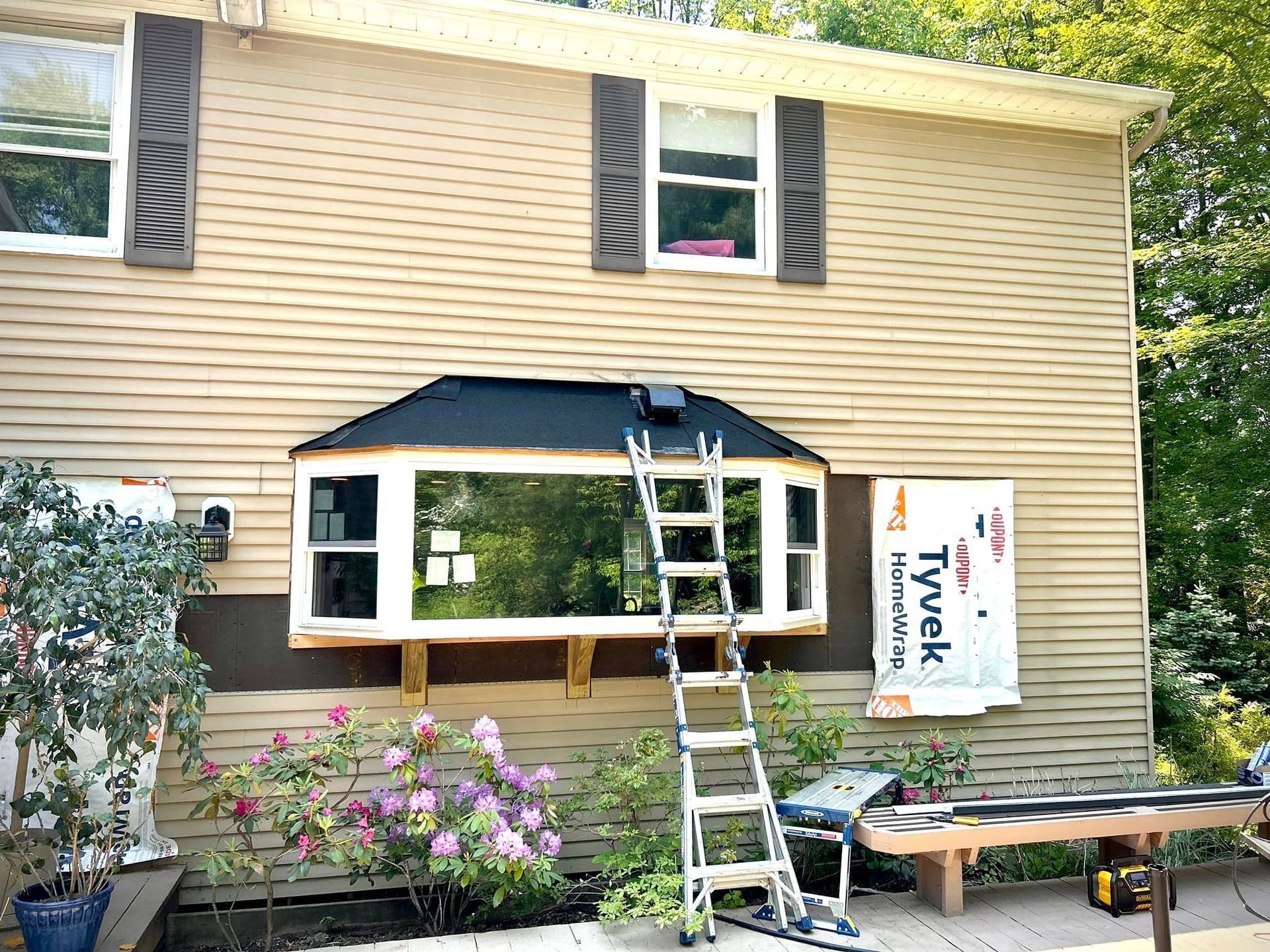 A house with a bay window is being remodeled.