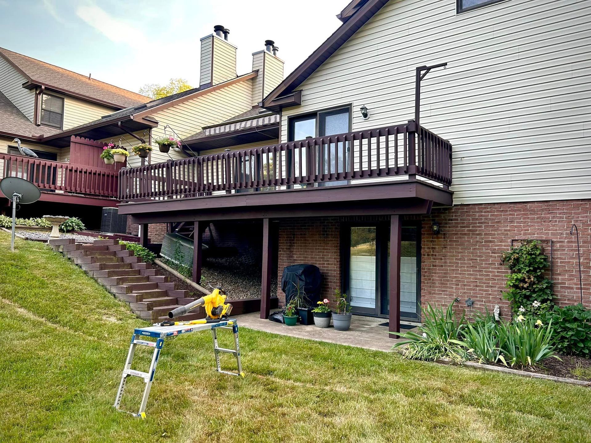 A wooden deck is being built on the side of a house.