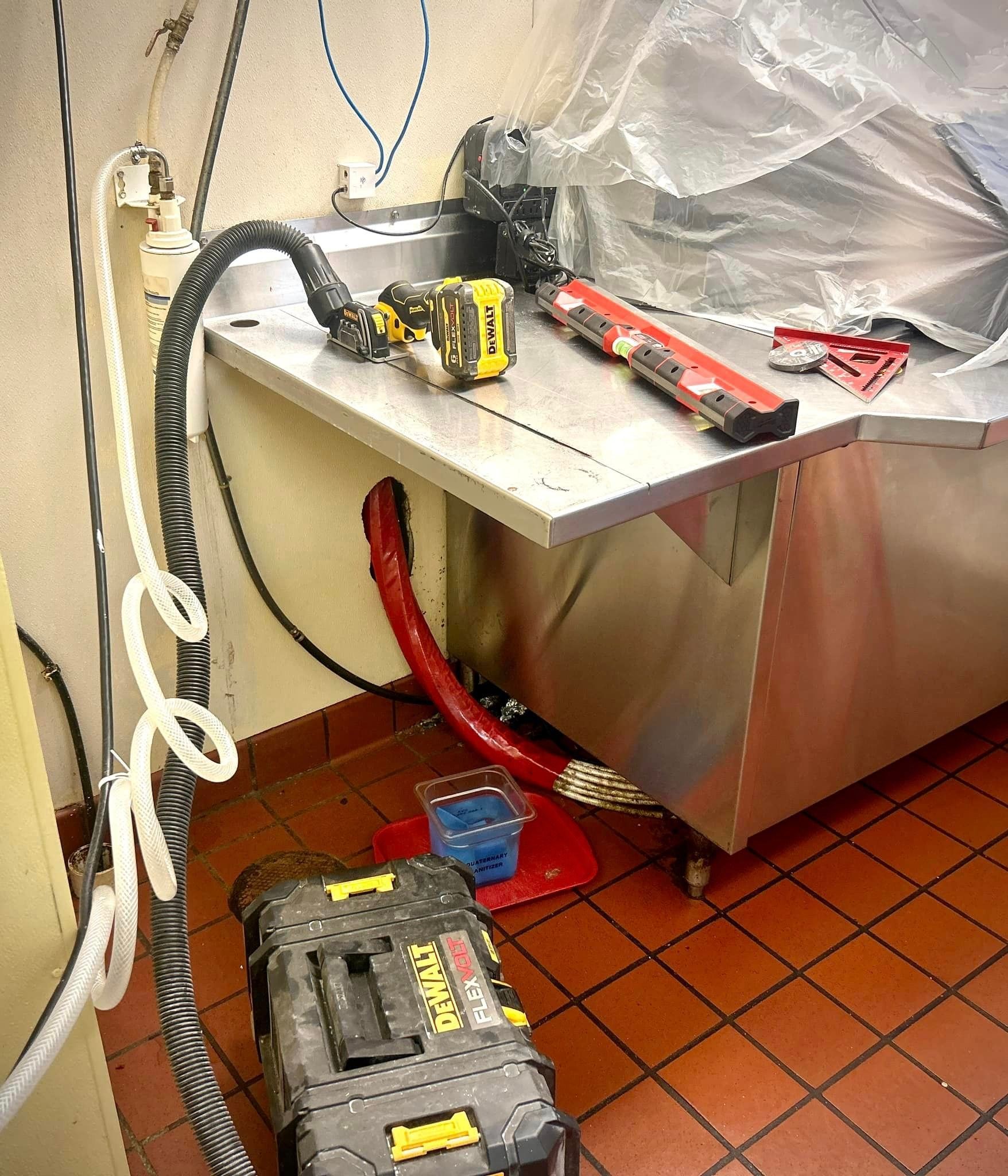 A dewalt vacuum cleaner is sitting next to a sink