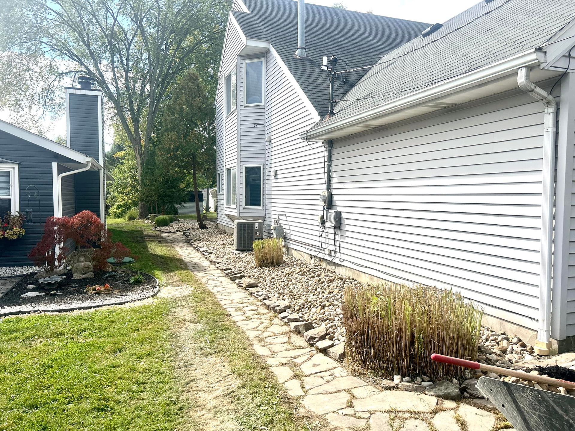 A house with a garage and a walkway leading to it.