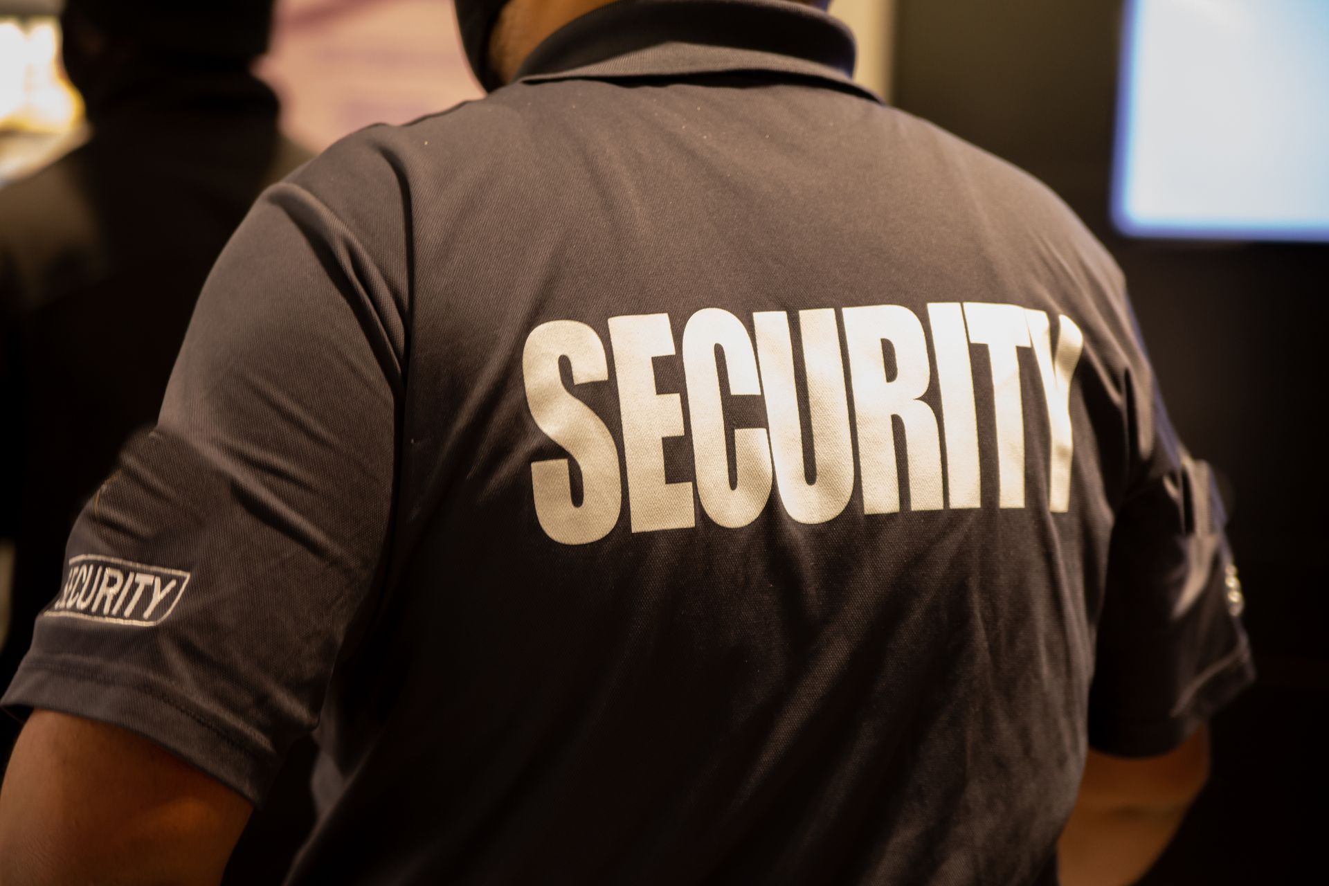 A man wearing a shirt that says security on the back