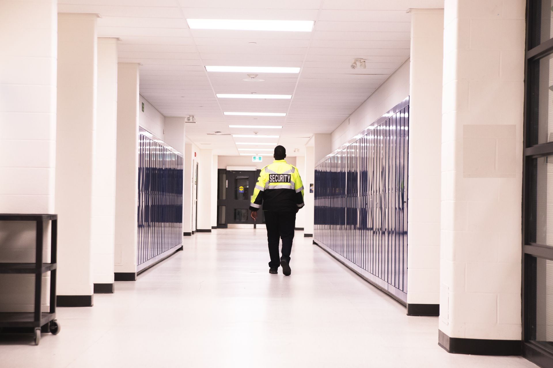 A man in a police uniform walks down a hallway