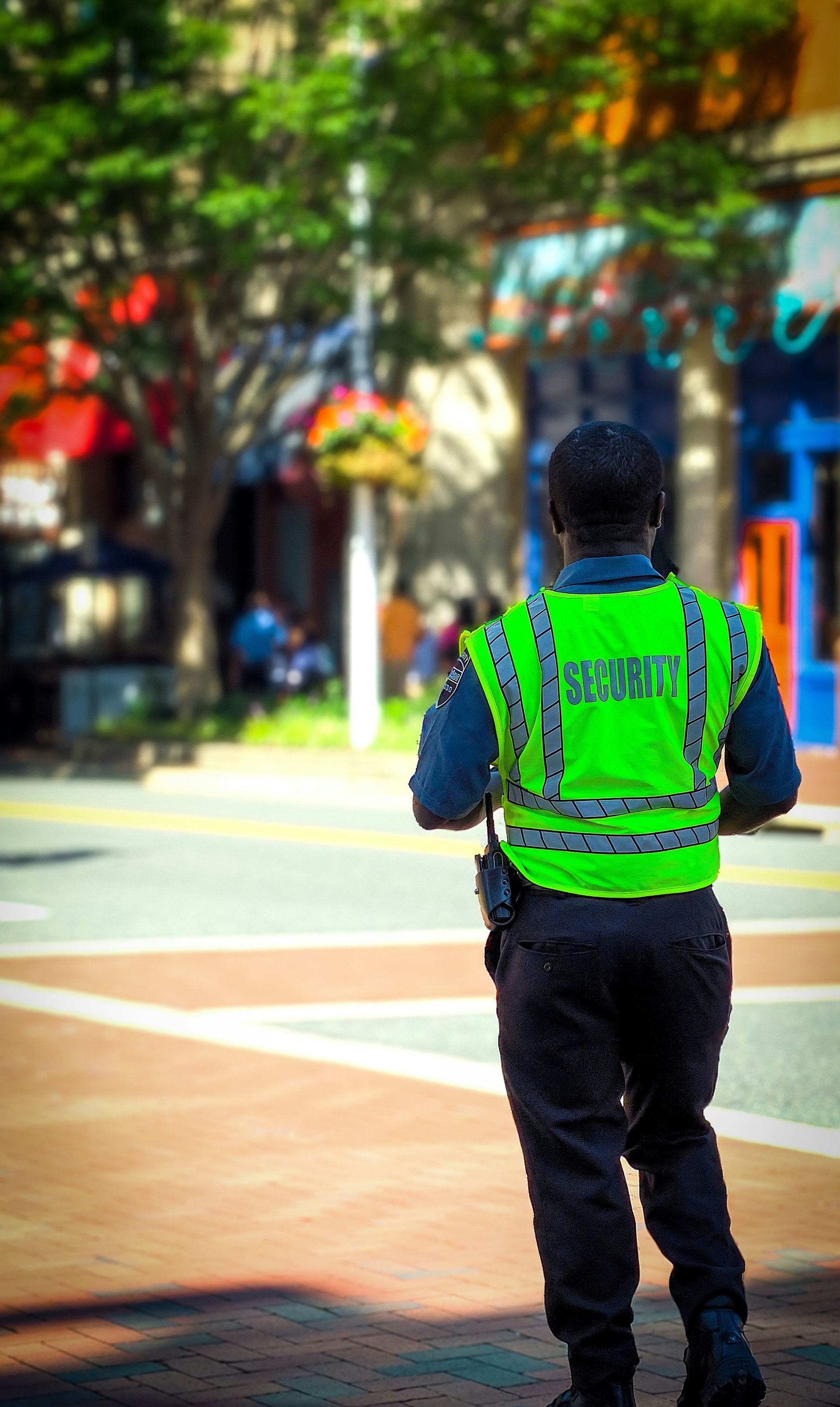 A police officer wearing a neon green vest that says ' hptc ' on it