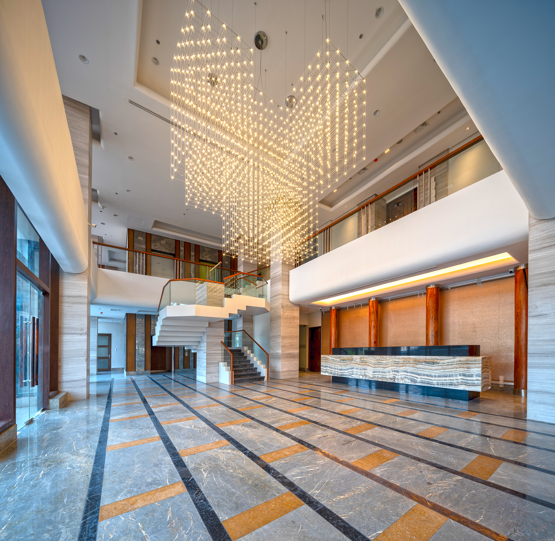 A large lobby with a large chandelier hanging from the ceiling