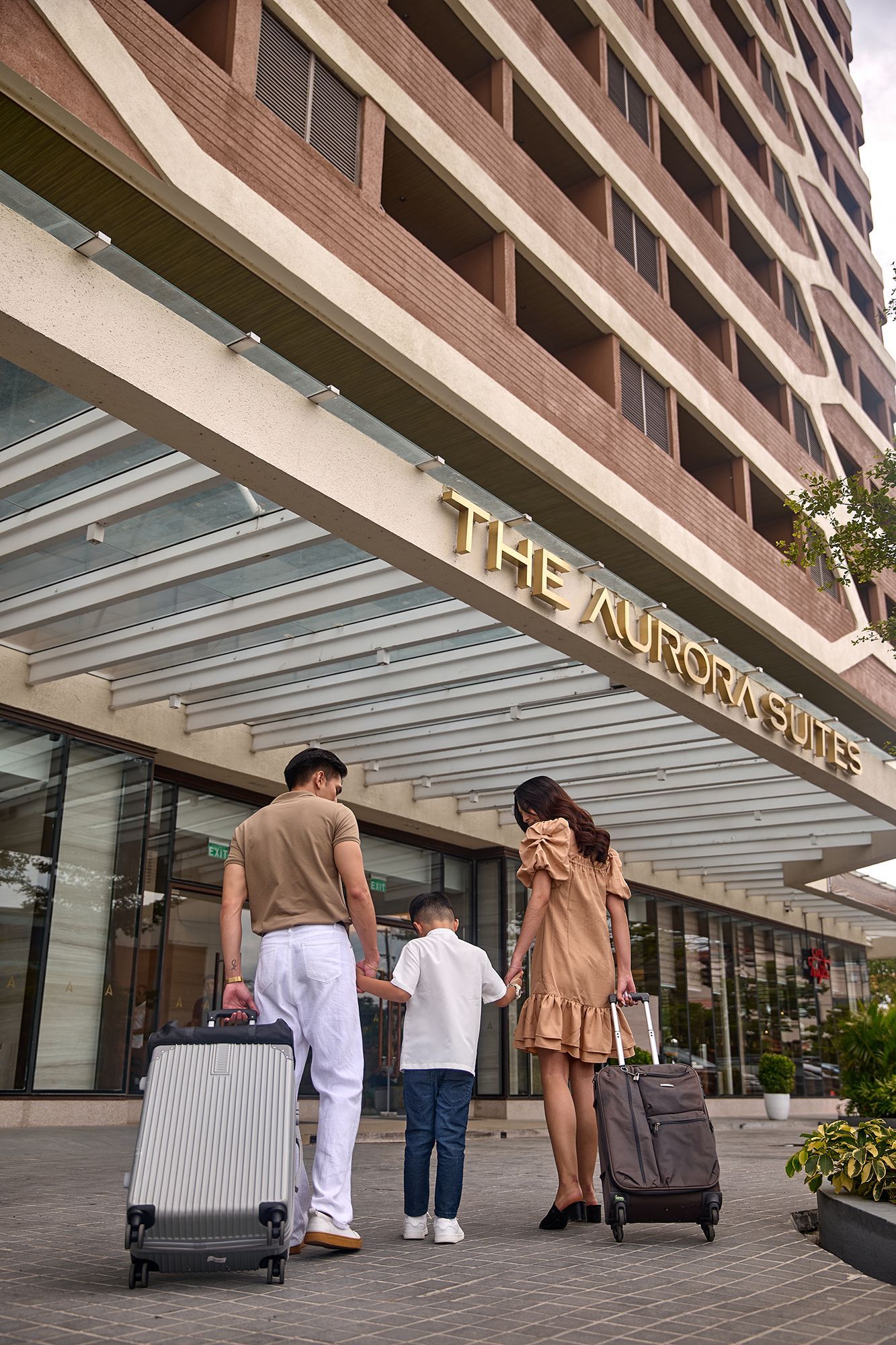 Family with luggage entering