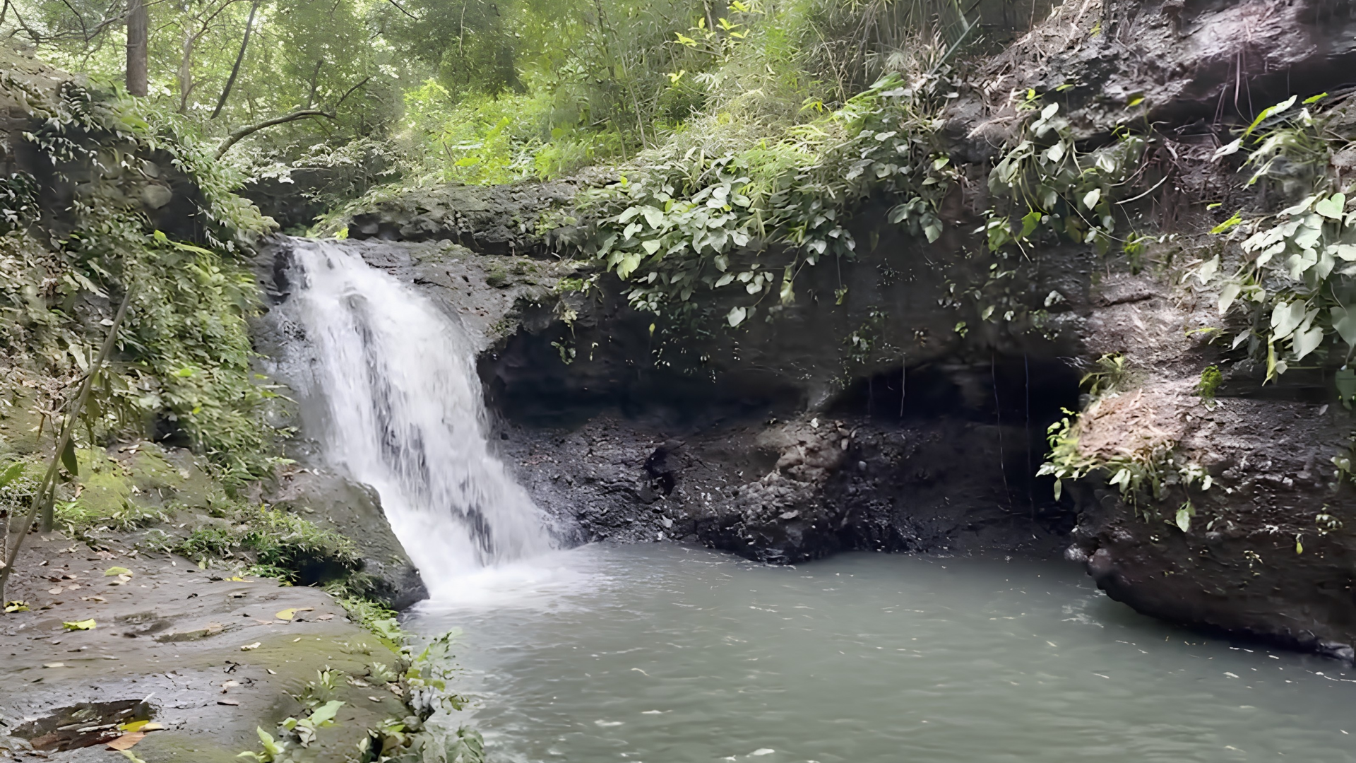 Cascading waterfall surrounded by lush tropical forest at El Kabayo near The Aurora Subic Hotel