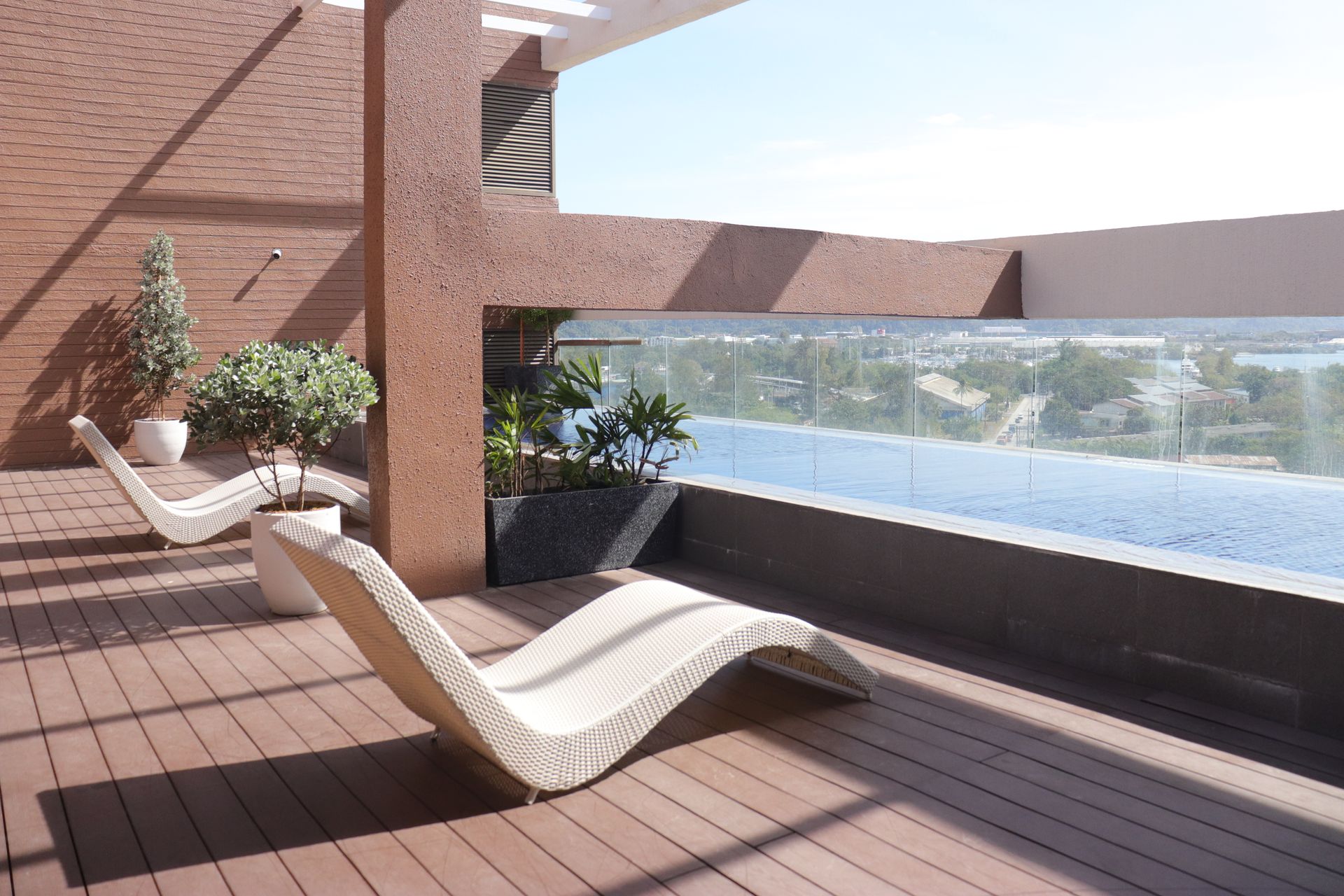 Two lounge chairs overlooking a swimming pool for your Subic bay staycation