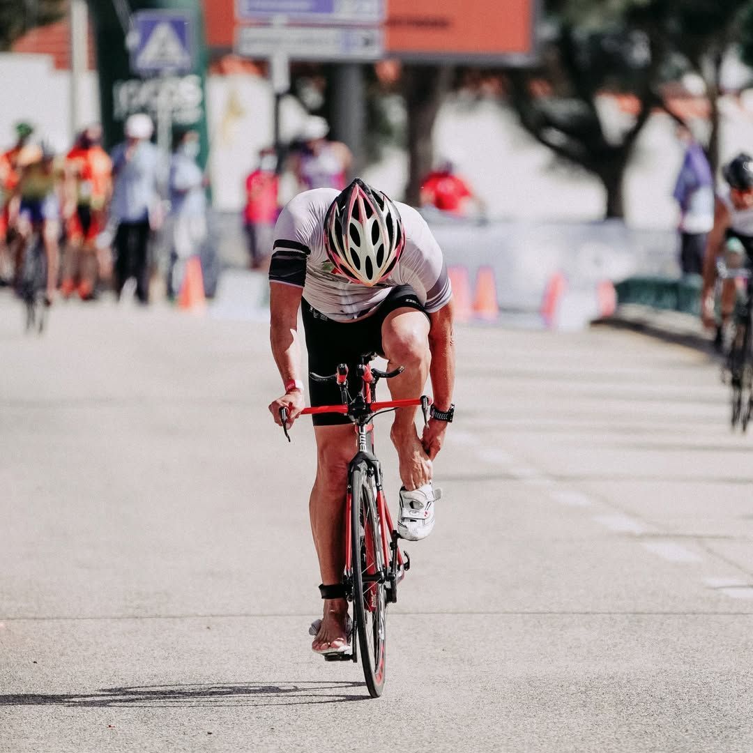 Cyclist racing at Ironman Subic Bay triathlon on red road bike