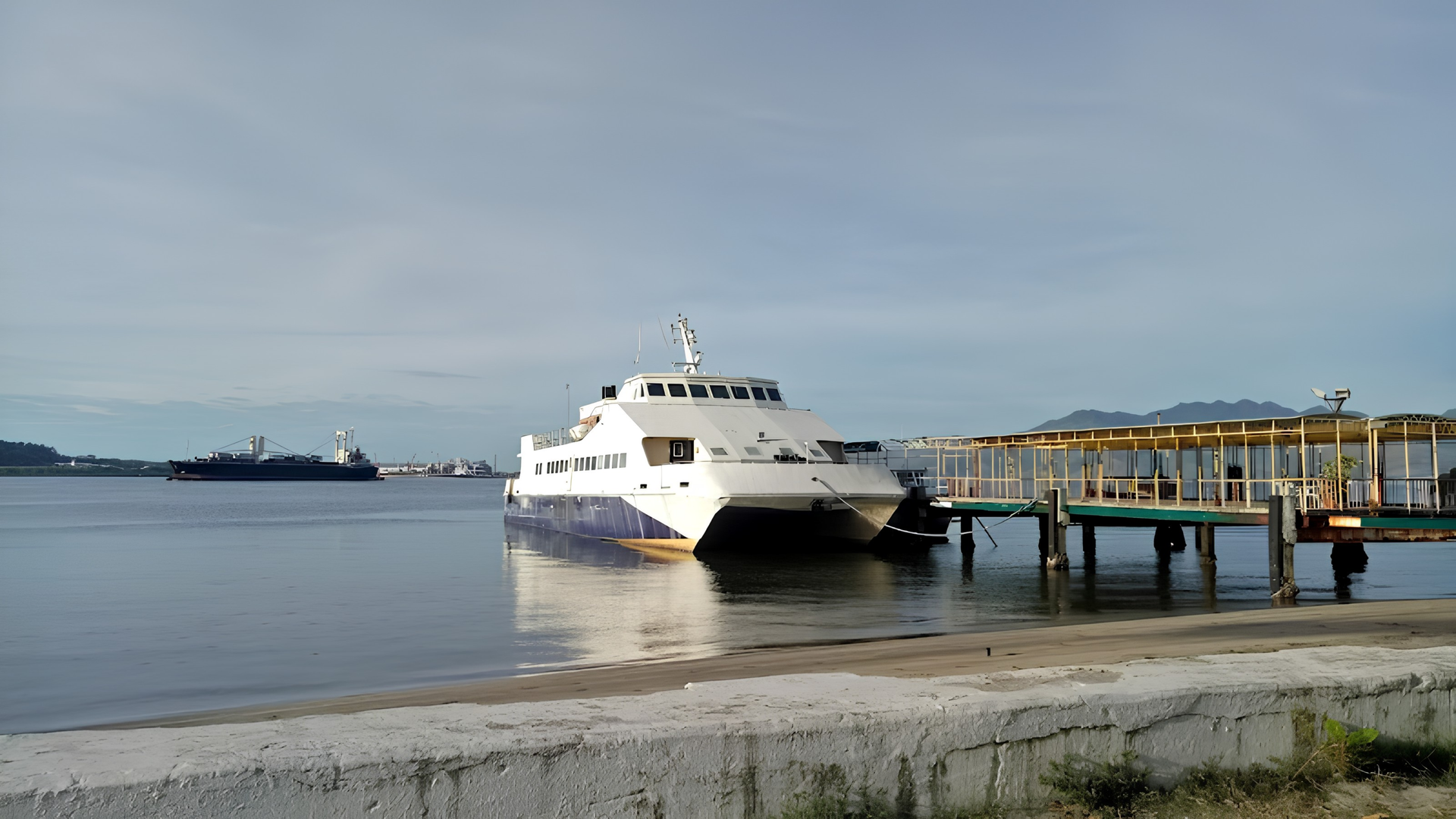 Scenic waterfront view of Subic Bay with boats docked along the shore near The Aurora Subic Hotel