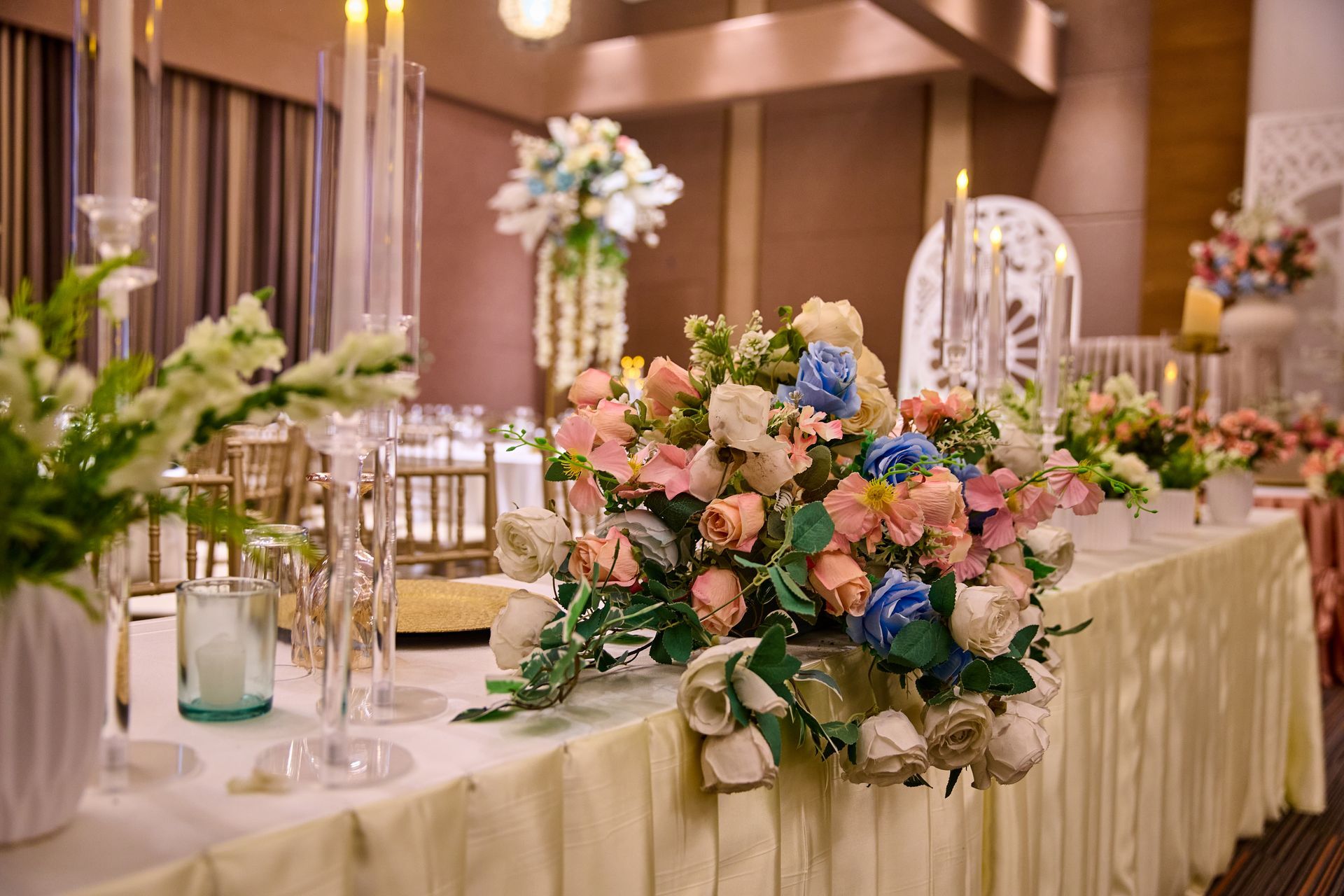 A long table with flowers and candles on in an events room in subic