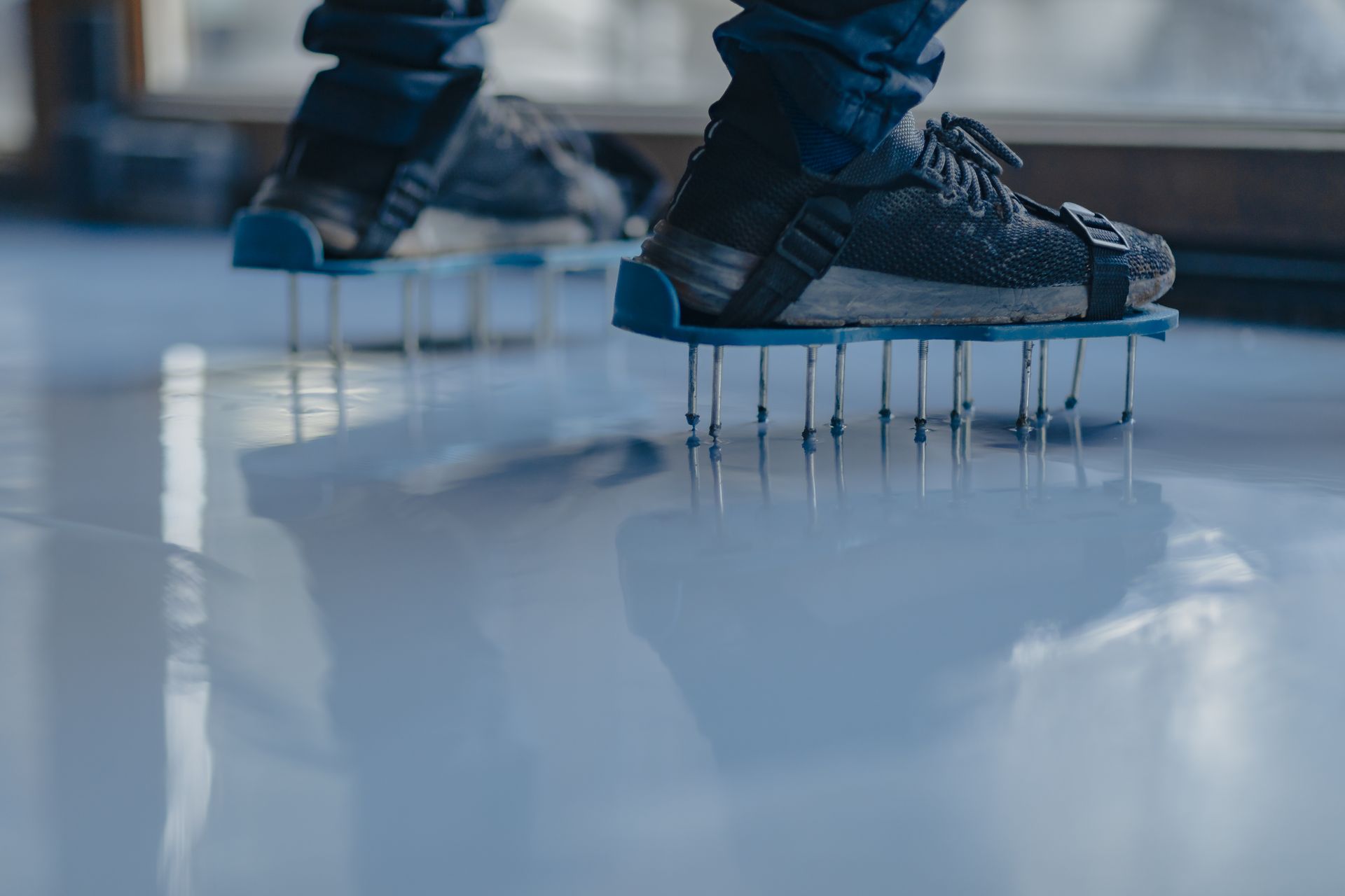 A person is wearing a pair of shoes with spikes on them.