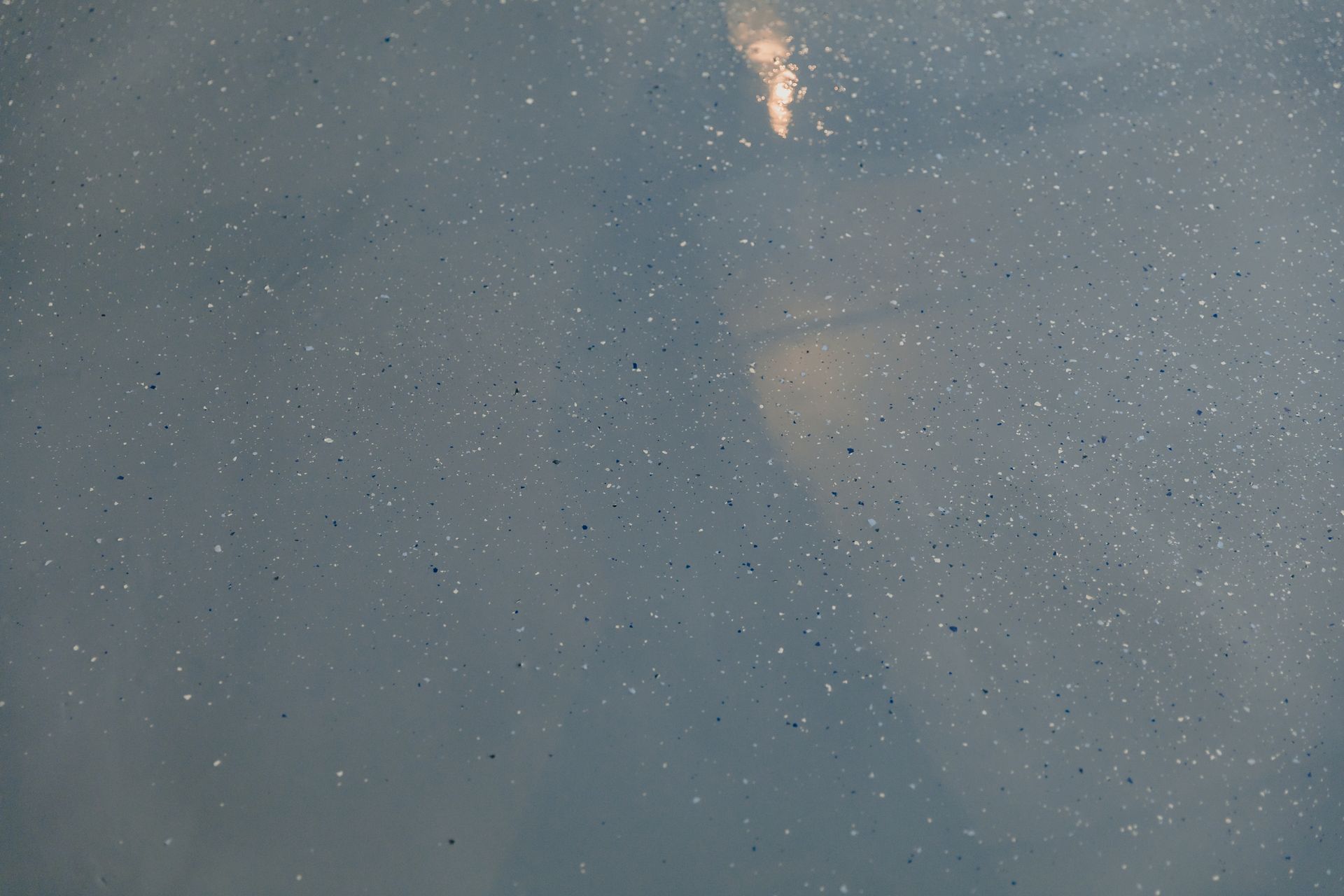 A close up of a gray surface with a lot of stars in the sky.