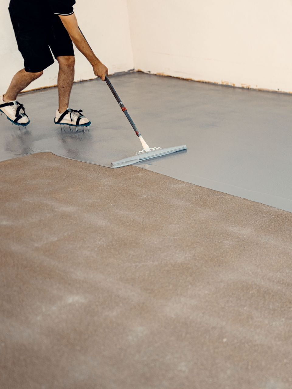 A man is using a mop to clean a carpeted floor