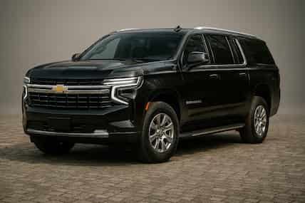 Black Chevrolet Tahoe SUV parked on a patterned surface.