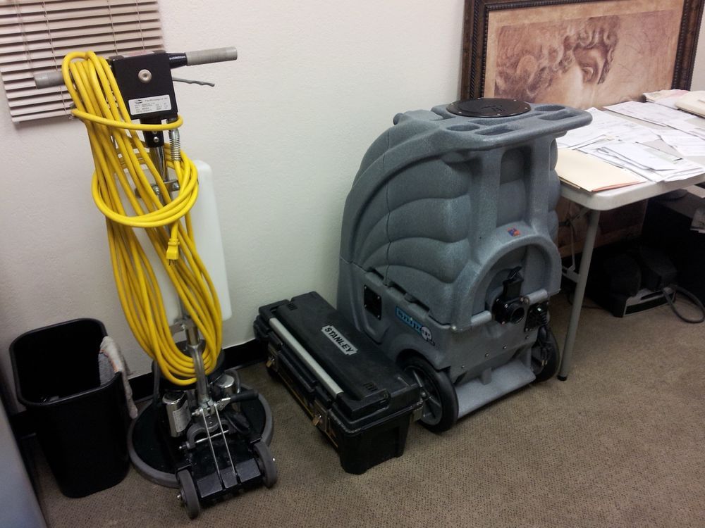 A vacuum cleaner with a yellow cord attached to it