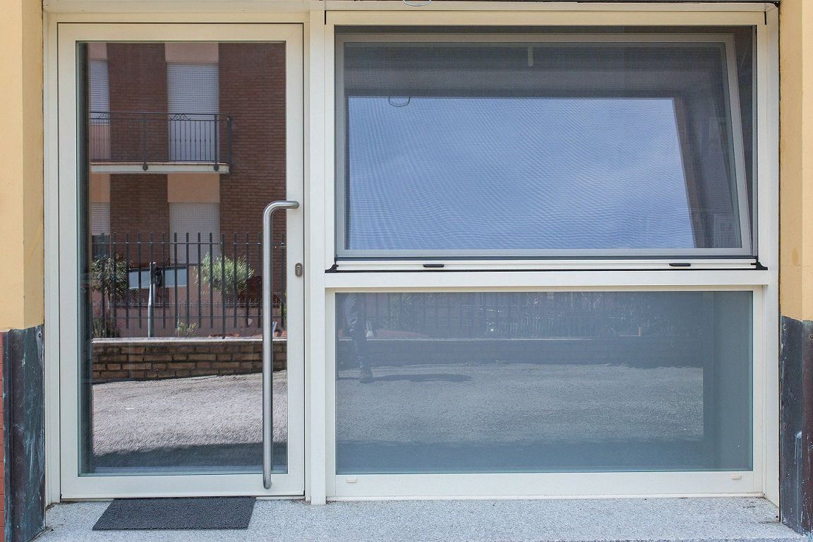 Portone in alluminio di ingresso ufficio con maniglione in acciaio realizzato da Cesari srl di Recanati
