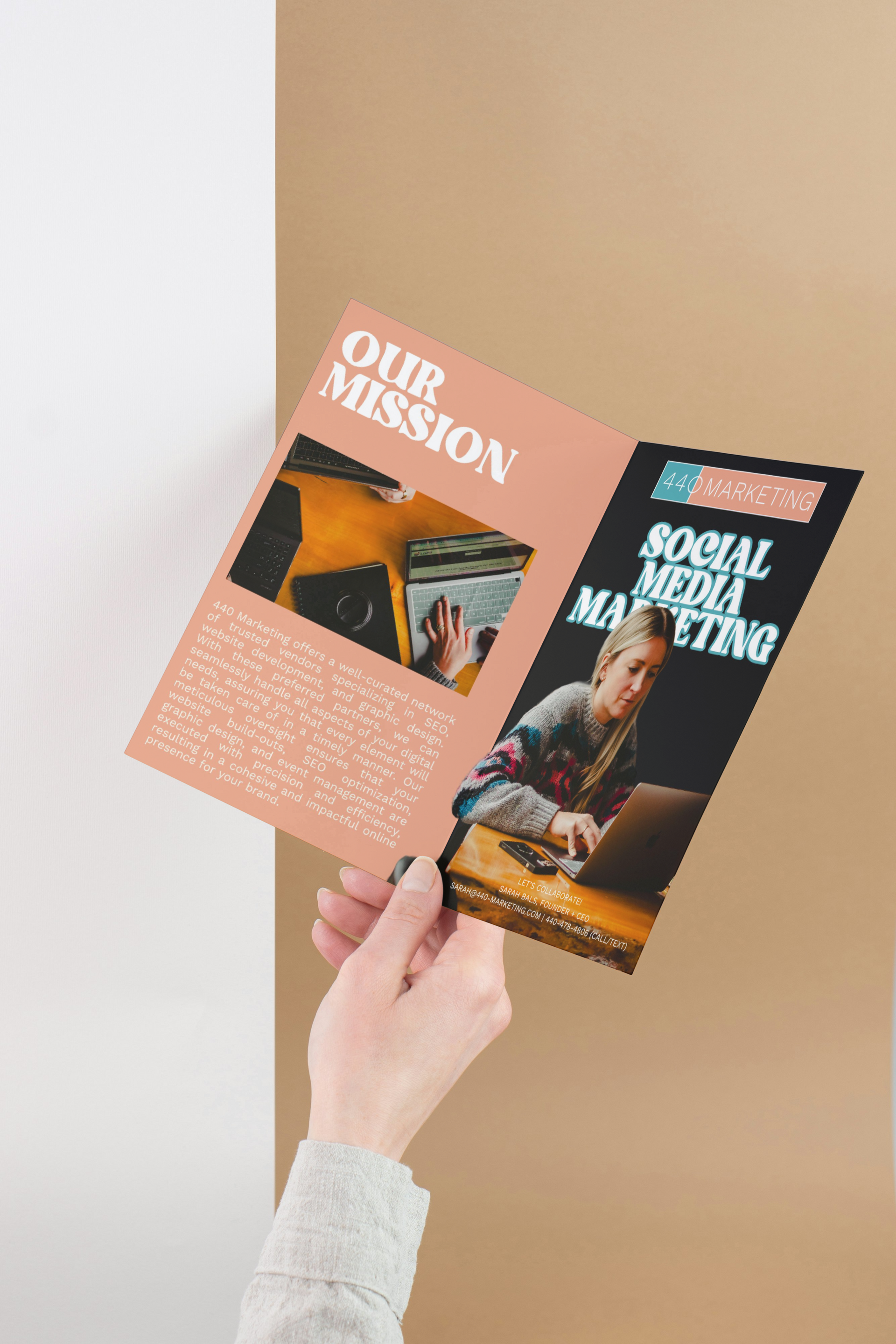 Person holding a brochure, the front of which displays “Social Media Marketing” and an image of a person at a laptop.