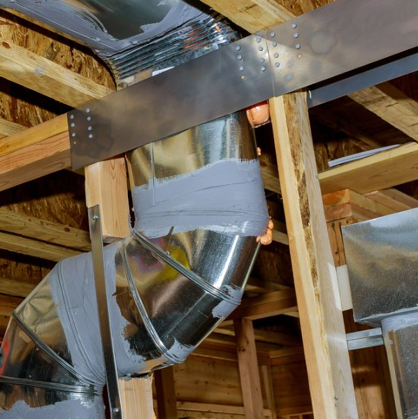 Male Hands Setting Up Ventilation System Indoors — White Bear Lake, MN — Reibel Heating & Air Conditioning