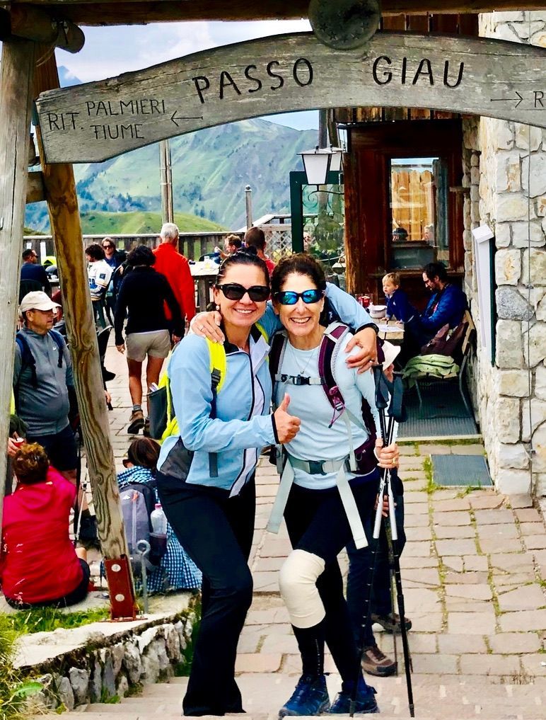 Two women smiling, posing under a
