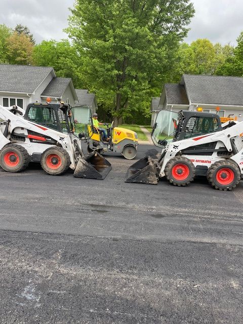 A group of construction workers are working on a road