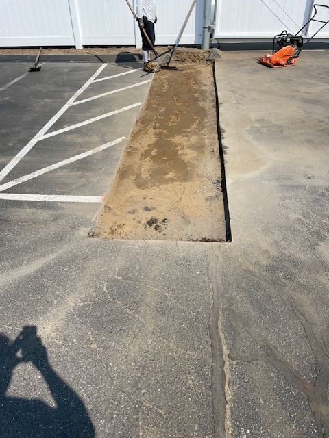 A warning triangle is sitting on the side of the road next to a pothole