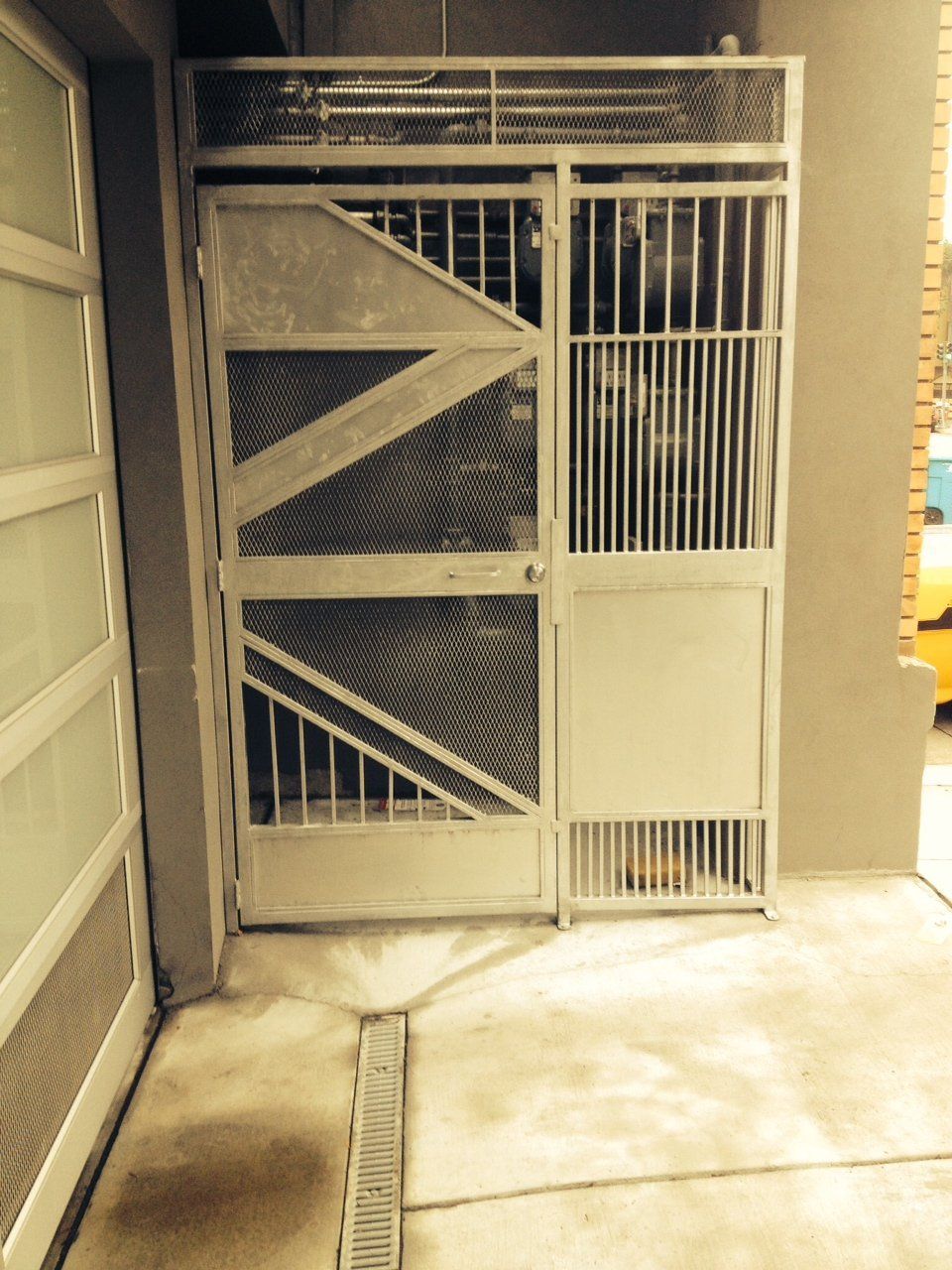 A white gate with a triangle design on it