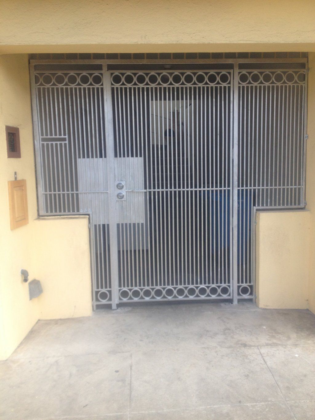 A metal gate is sitting in front of a building.