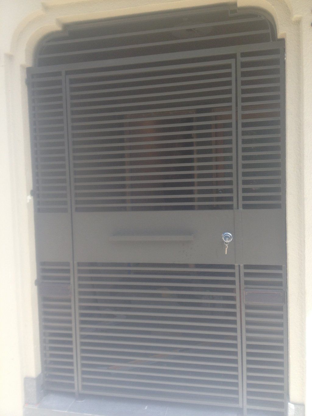 A close up of a metal gate with a key in it.