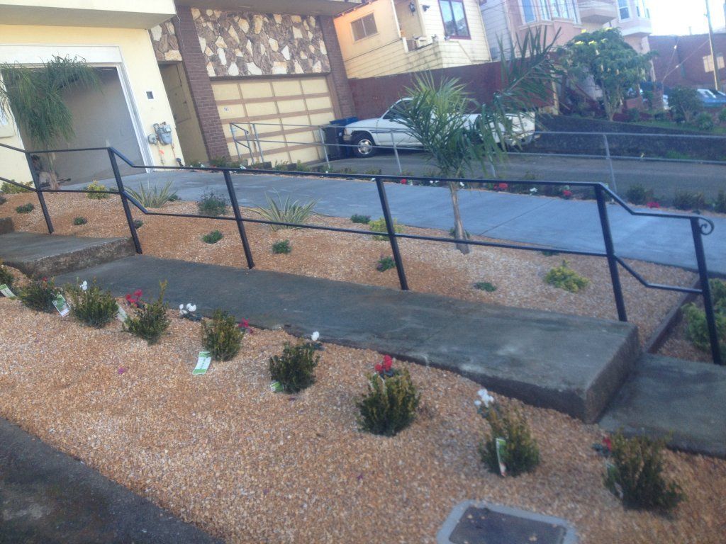 A staircase with a railing leading up to a house