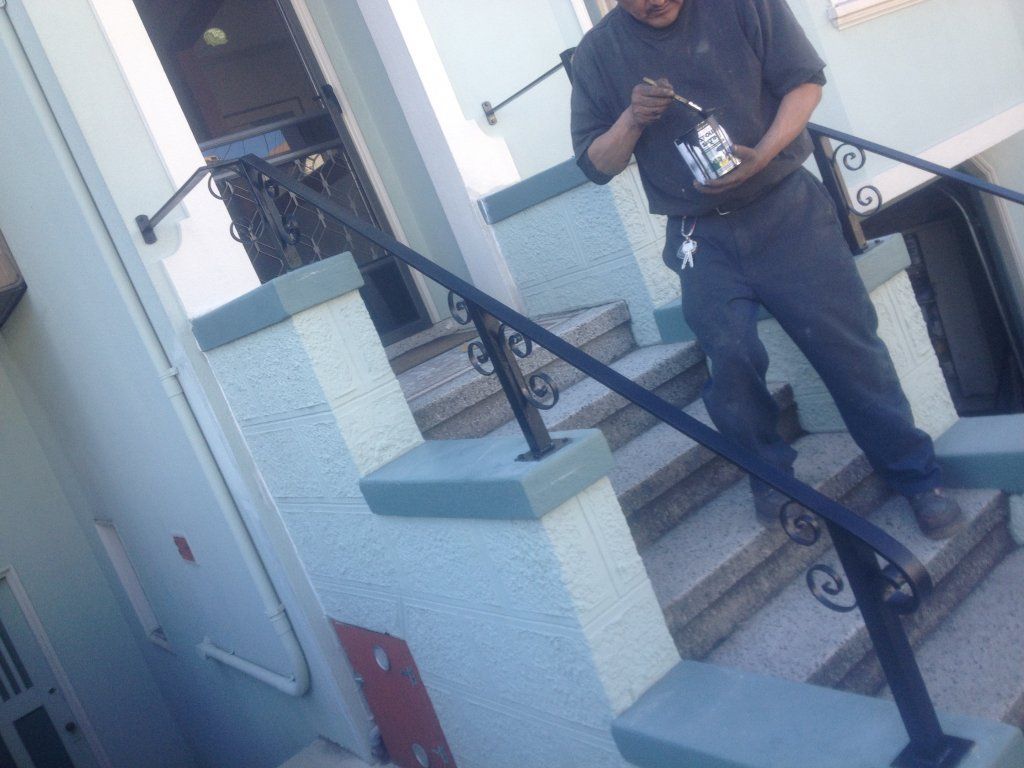 A man is standing on a set of stairs holding a cell phone