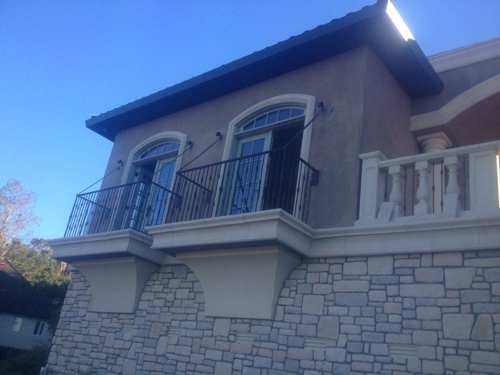 A building with a balcony on the side of it