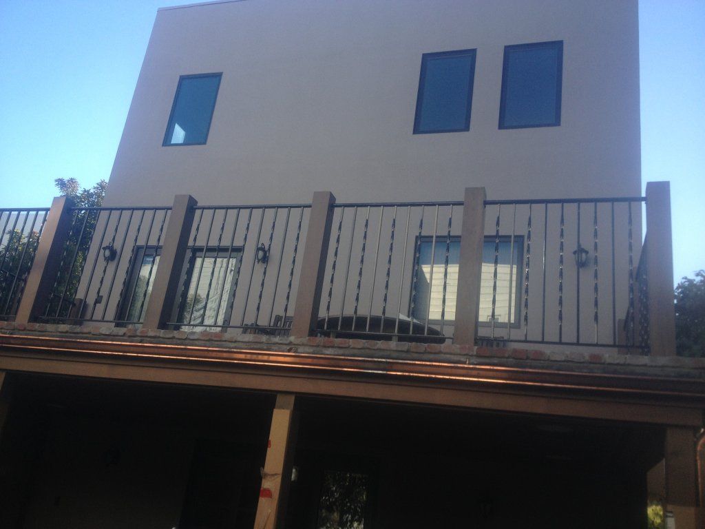 A large white building with a balcony on the top of it