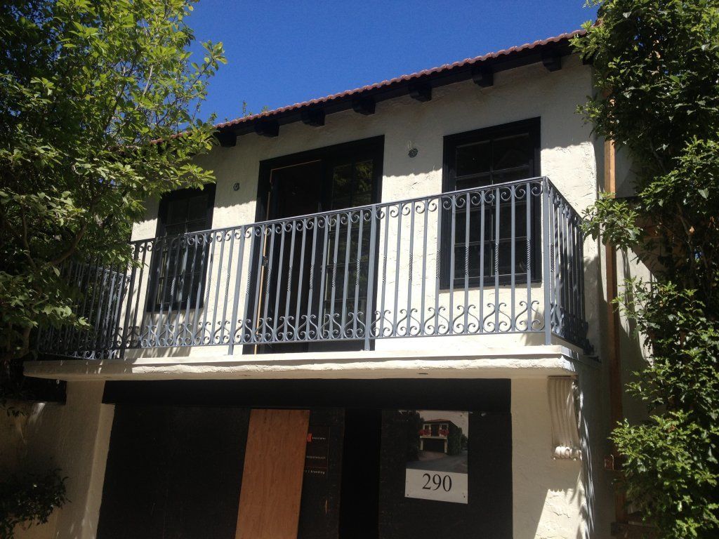 A house with a balcony and the number 299 on it