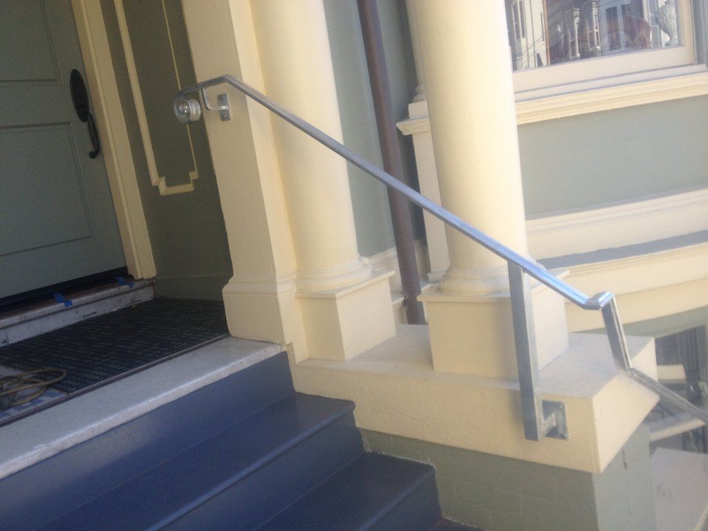 A staircase with a metal railing on the side of it