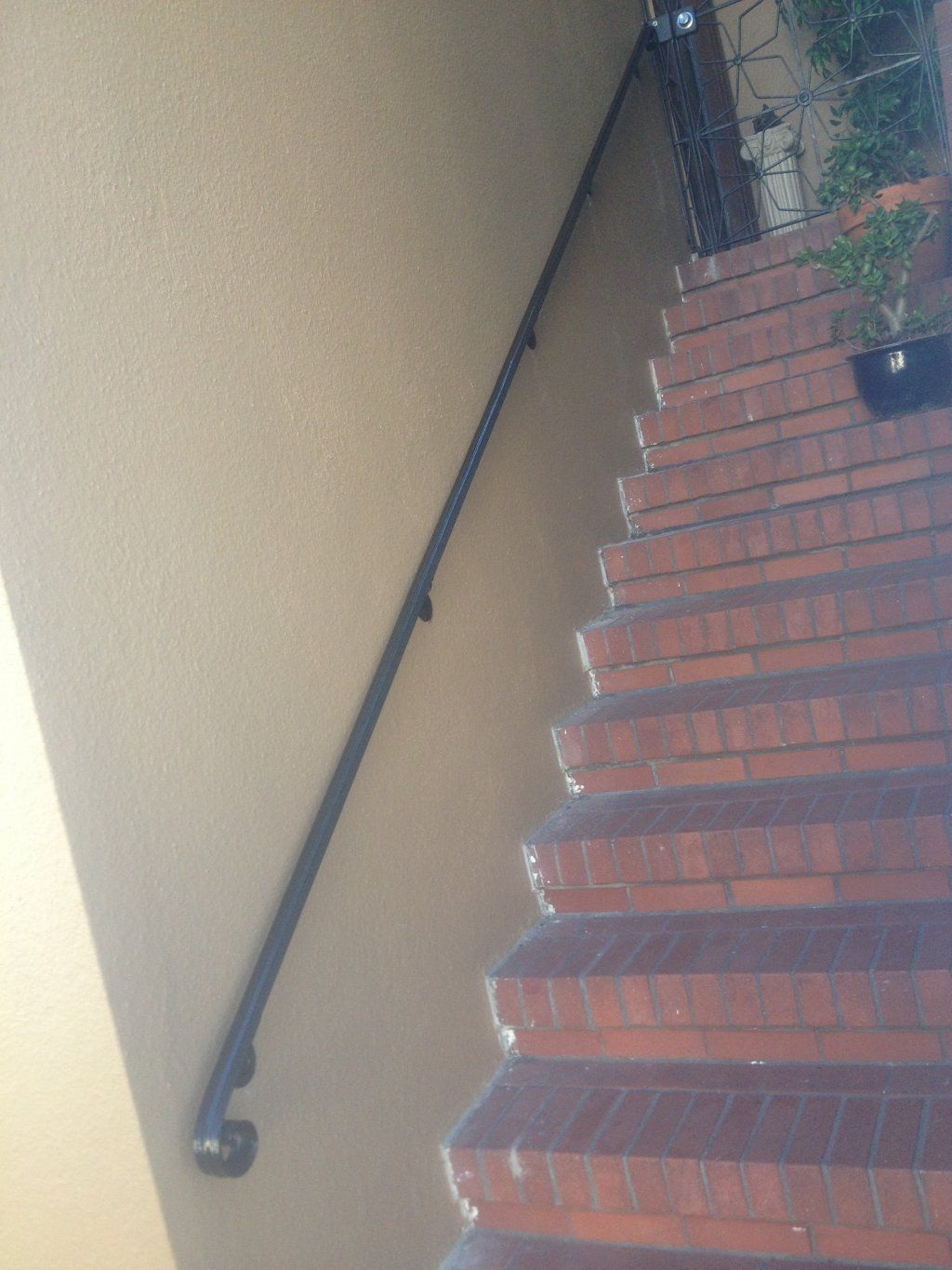 A set of stairs with a hand rail on the side of them