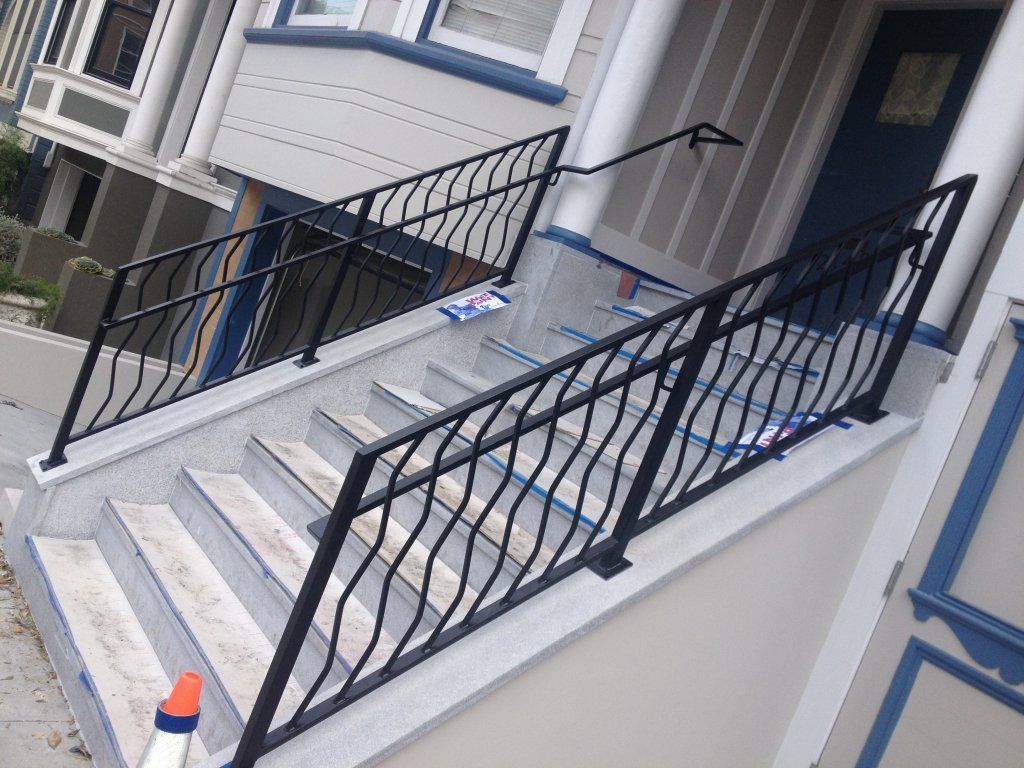 A set of stairs with a wrought iron railing