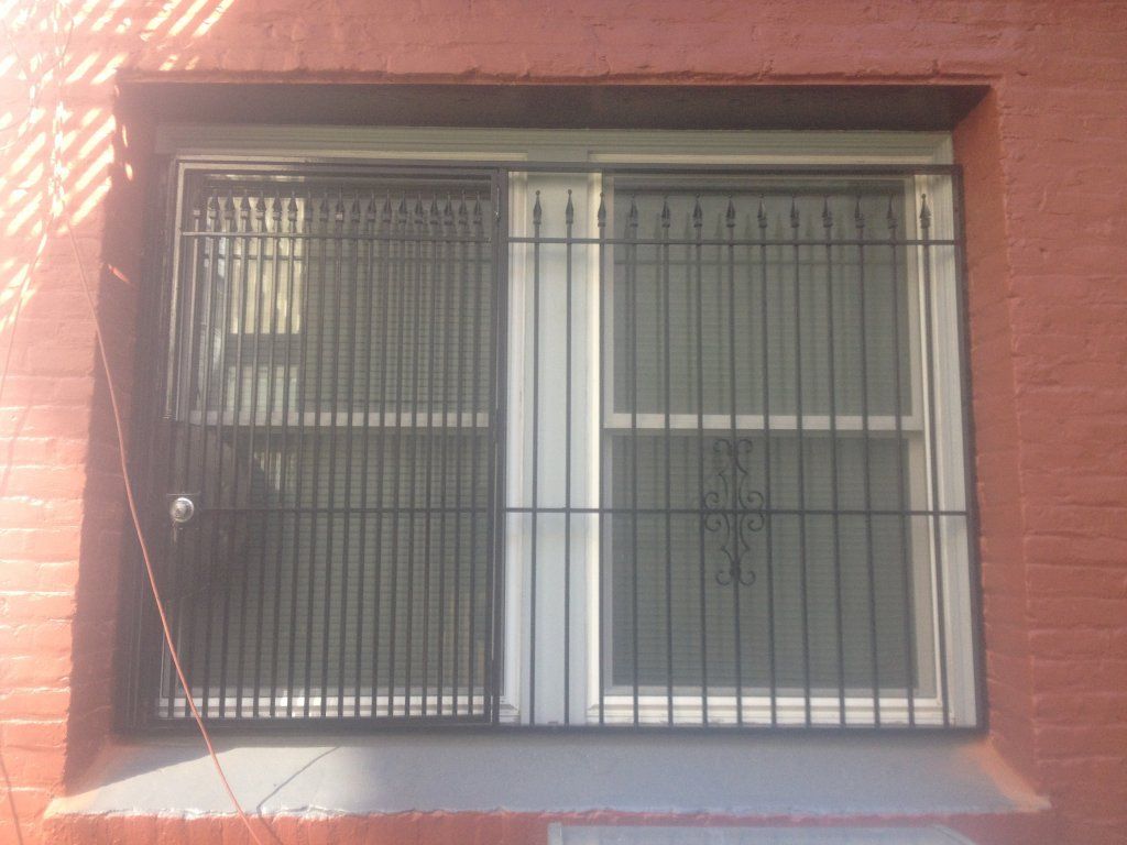 A brick building with a window with bars on it
